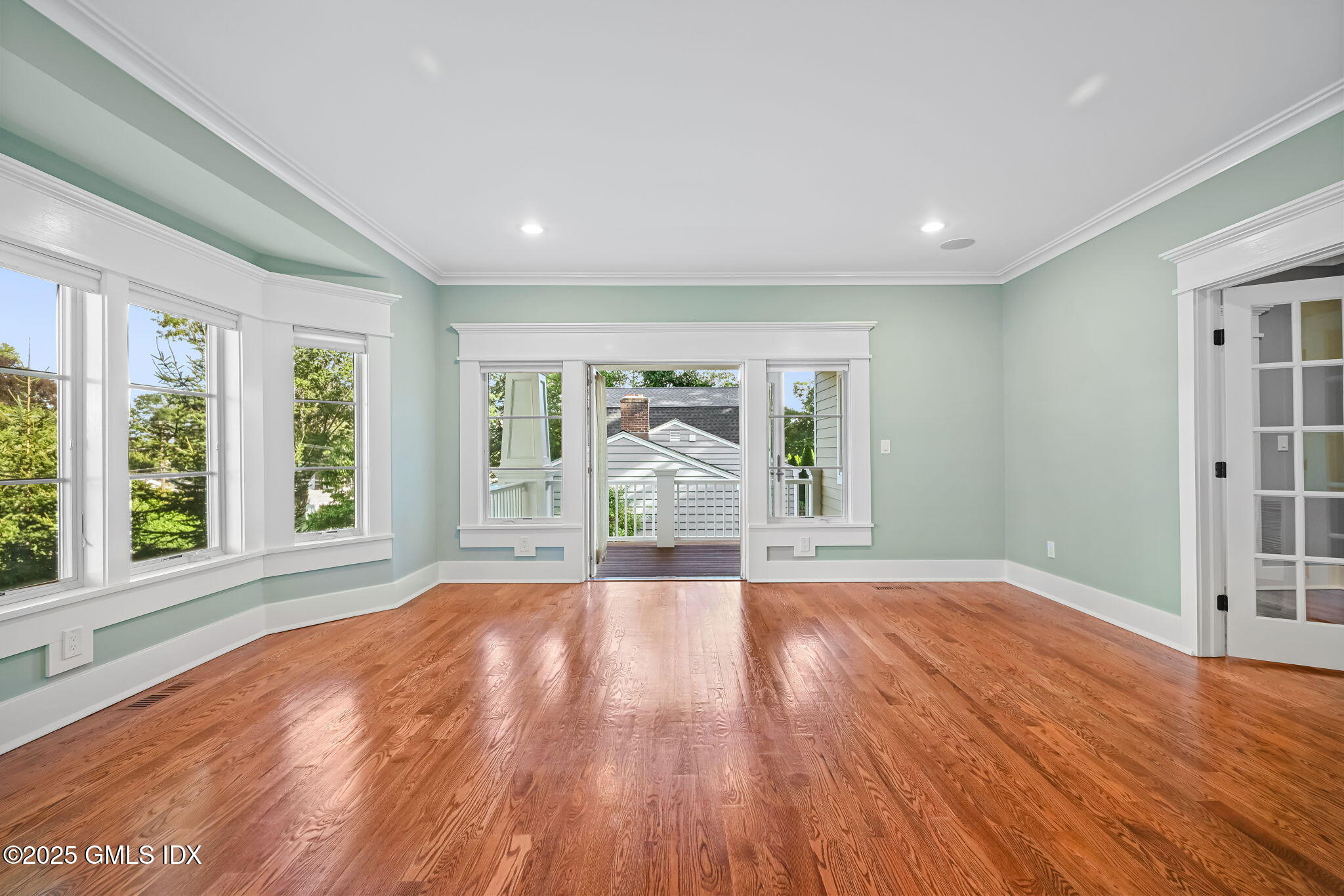 12 Old Wagon Road Old Greenwich, CT 06870 - Photo 6 of 57 a view of an empty room with wooden floor and a window