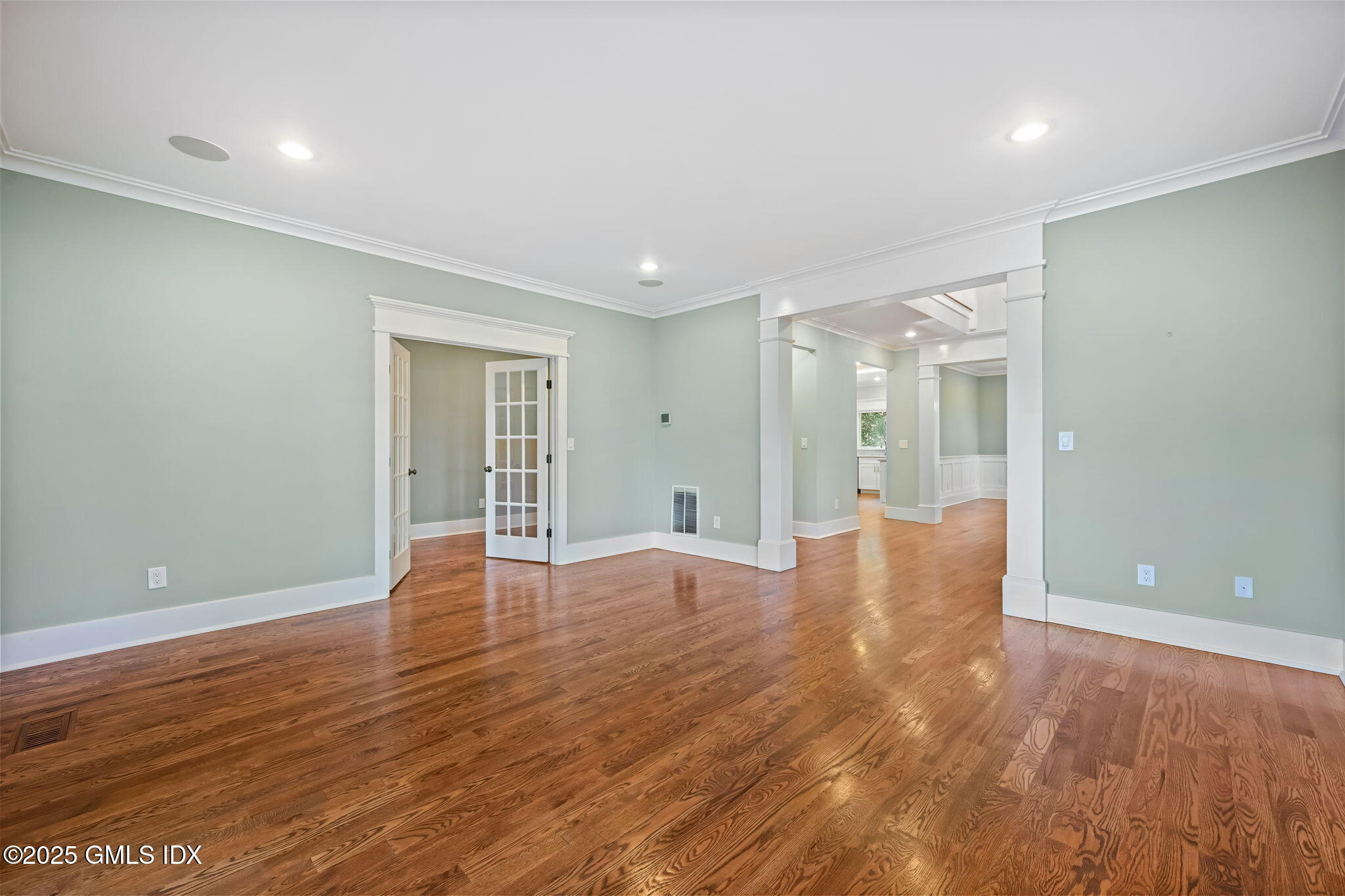 12 Old Wagon Road Old Greenwich, CT 06870 - Photo 7 of 57 a view of an empty room with wooden floor and a window