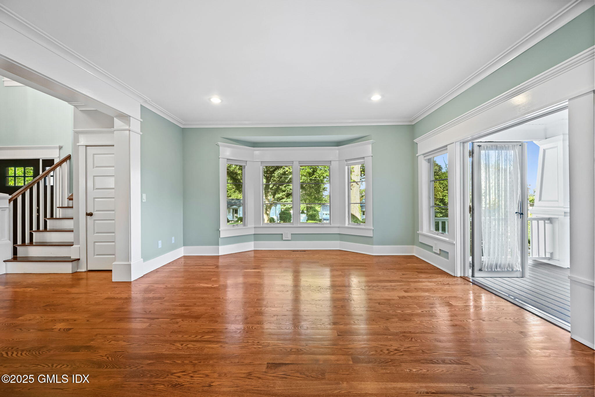 12 Old Wagon Road Old Greenwich, CT 06870 - Photo 8 of 57 a view of an empty room with wooden floor and a window