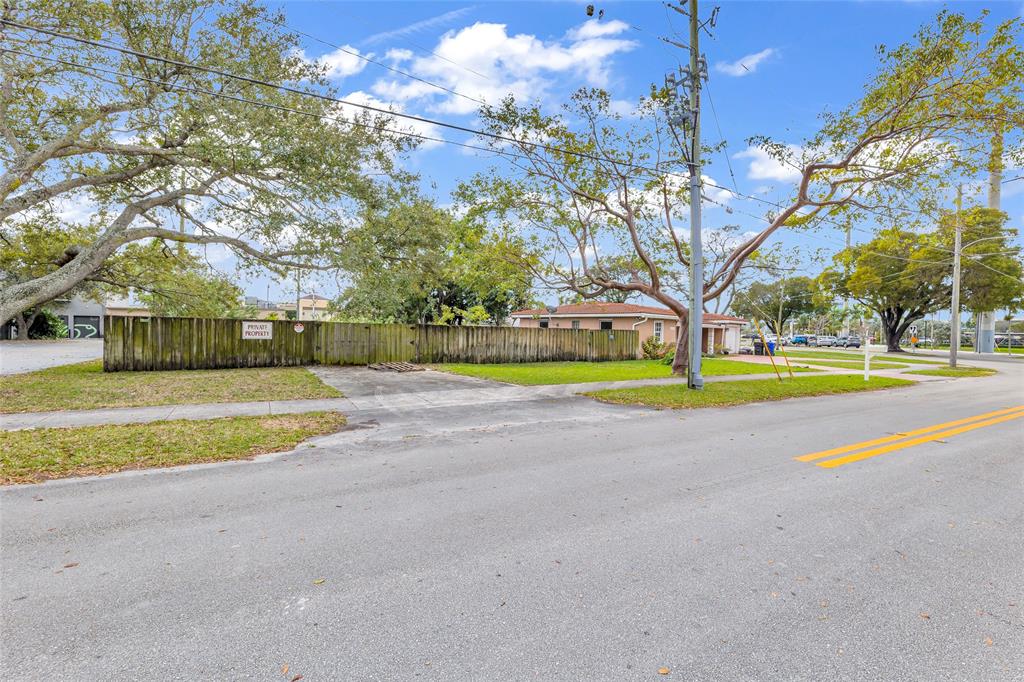 5912 Tyler Street Hollywood, FL 33021 - Photo 11 of 17 a view of the house with a yard and palm trees
