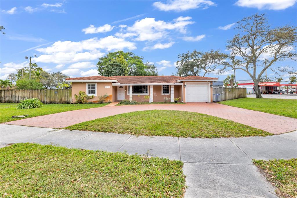 5912 Tyler Street Hollywood, FL 33021 - Photo 10 of 17 front view of a house with a yard