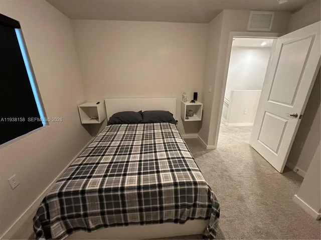 a bedroom with a bed and a mirror