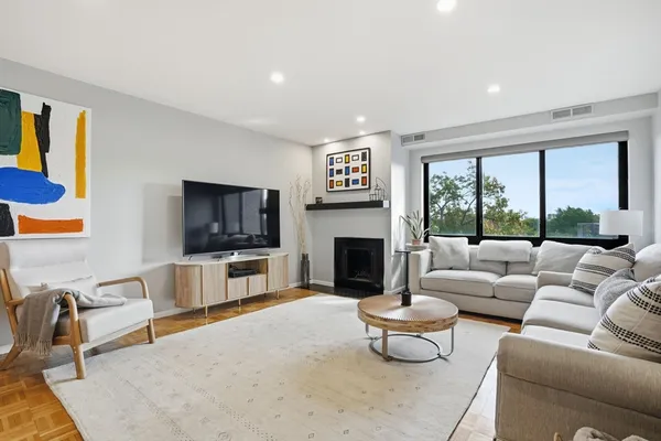 a living room with furniture a flat screen tv and a fireplace