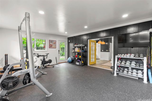 a spacious bedroom with a large bed and a chandelier
