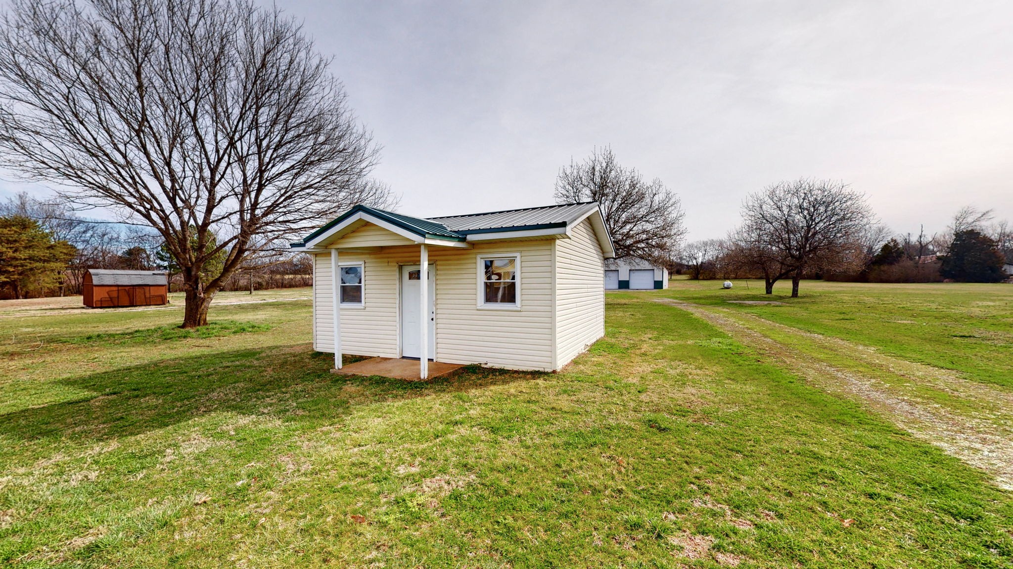 3149 Les Chappell Road Spring Hill, TN 37174 - Photo 43 of 48 a view of a house with a big yard and large trees