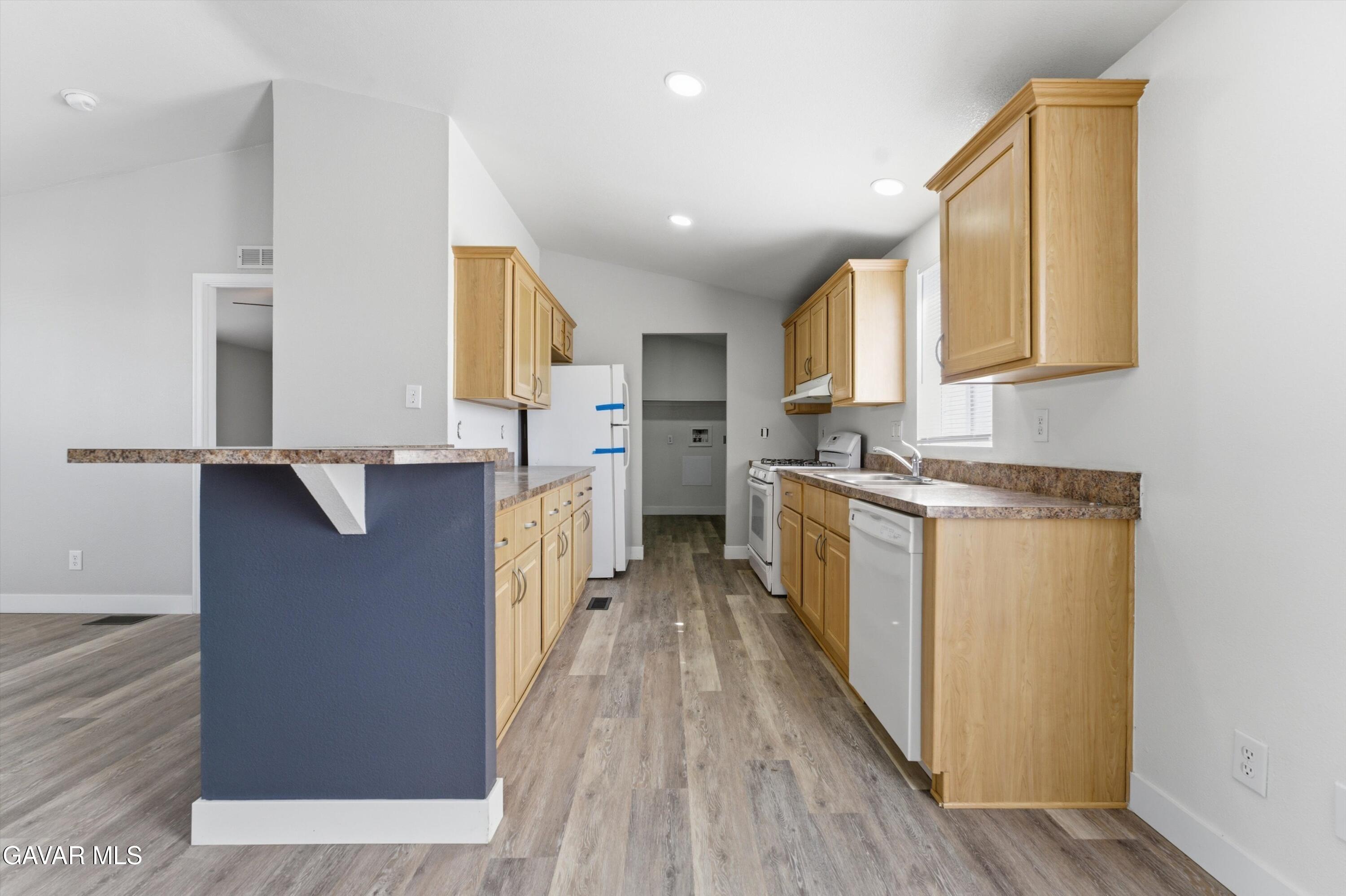 20843 Waalew Road Apple Valley, CA 92307 - Photo 10 of 40 a kitchen with cabinets and wooden floor