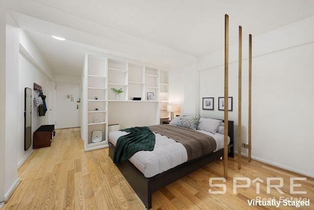 Undisclosed Address Manhattan, NY 10019 - Photo 10 of 20 a bedroom with a bed and a walk in closet