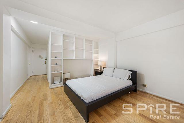 Undisclosed Address Manhattan, NY 10019 - Photo 12 of 20 a bedroom with a bed and wooden floor