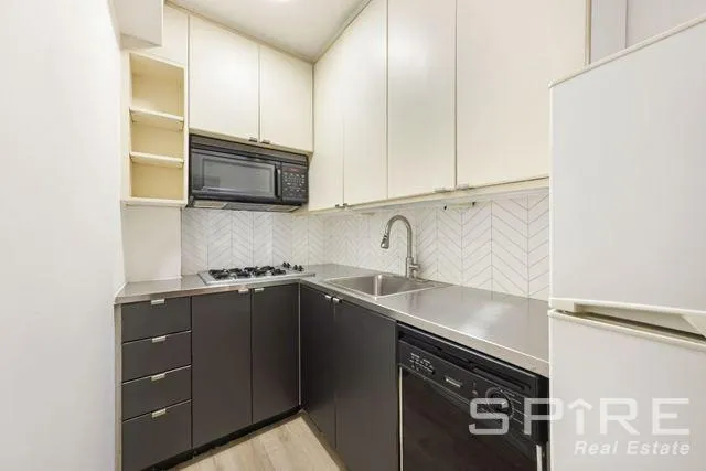 a kitchen with a sink and cabinets