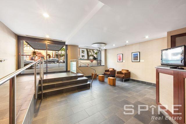 Undisclosed Address Manhattan, NY 10019 - Photo 17 of 20 a living room with furniture and a flat screen tv