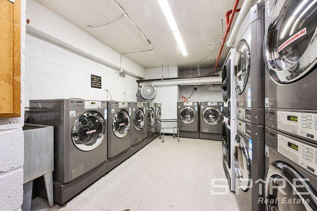 Undisclosed Address Manhattan, NY 10019 - Photo 18 of 20 a utility room with multiple dryer and washer