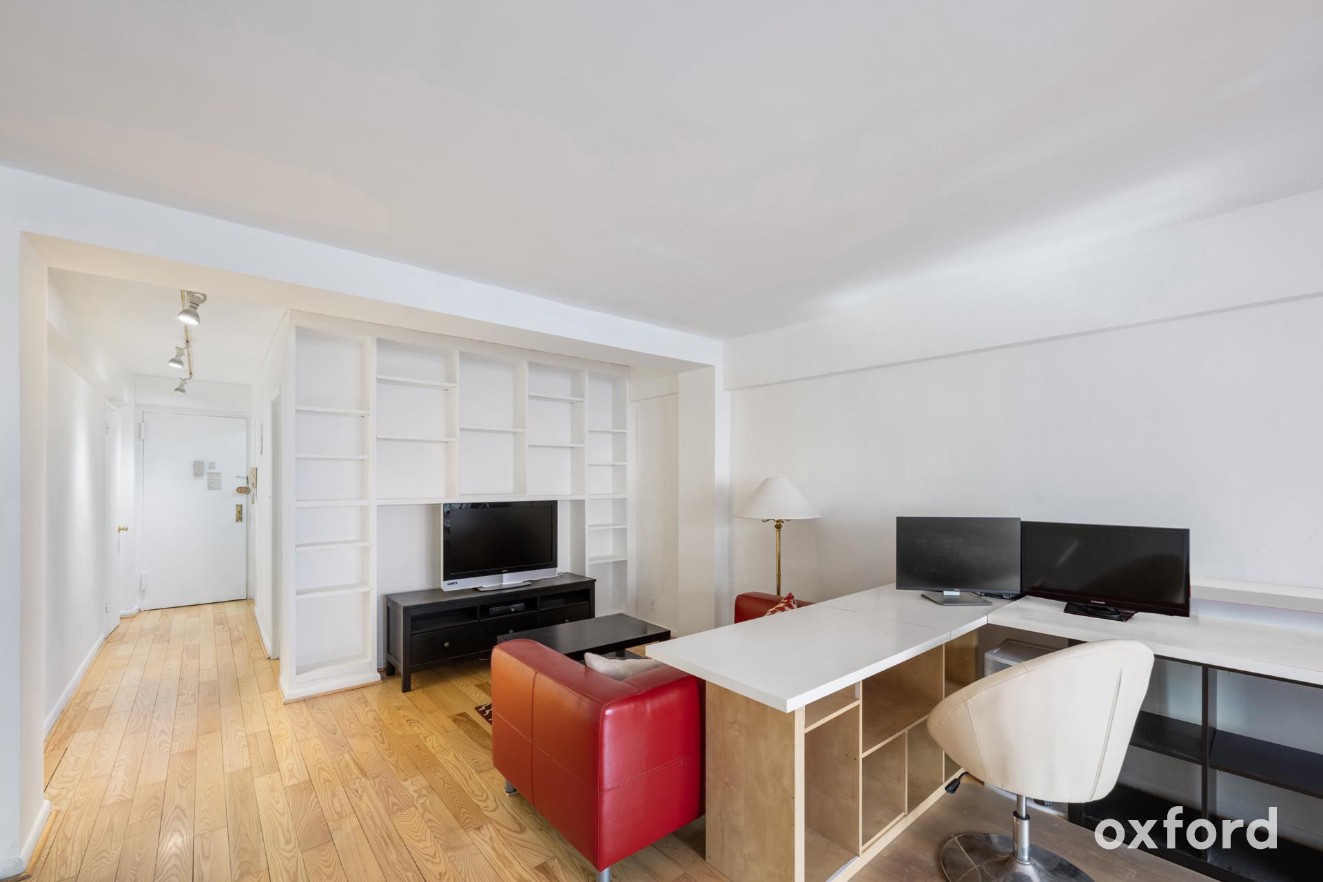 Undisclosed Address Manhattan, NY 10019 - Photo 5 of 20 a living room with furniture and a flat screen tv
