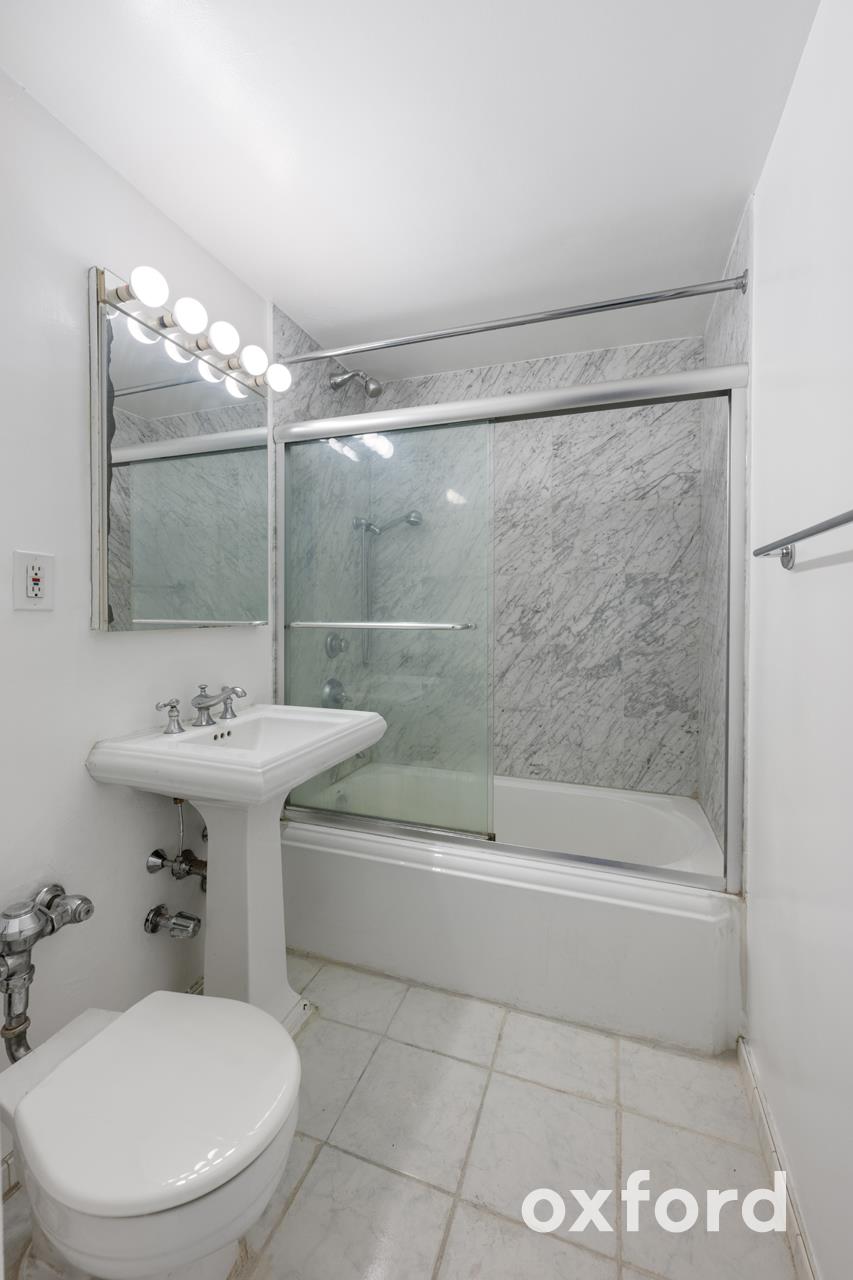 Undisclosed Address Manhattan, NY 10019 - Photo 9 of 20 a bathroom with a sink mirror toilet and bathtub