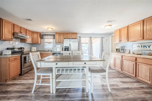 a kitchen with stainless steel appliances granite countertop a sink and cabinets