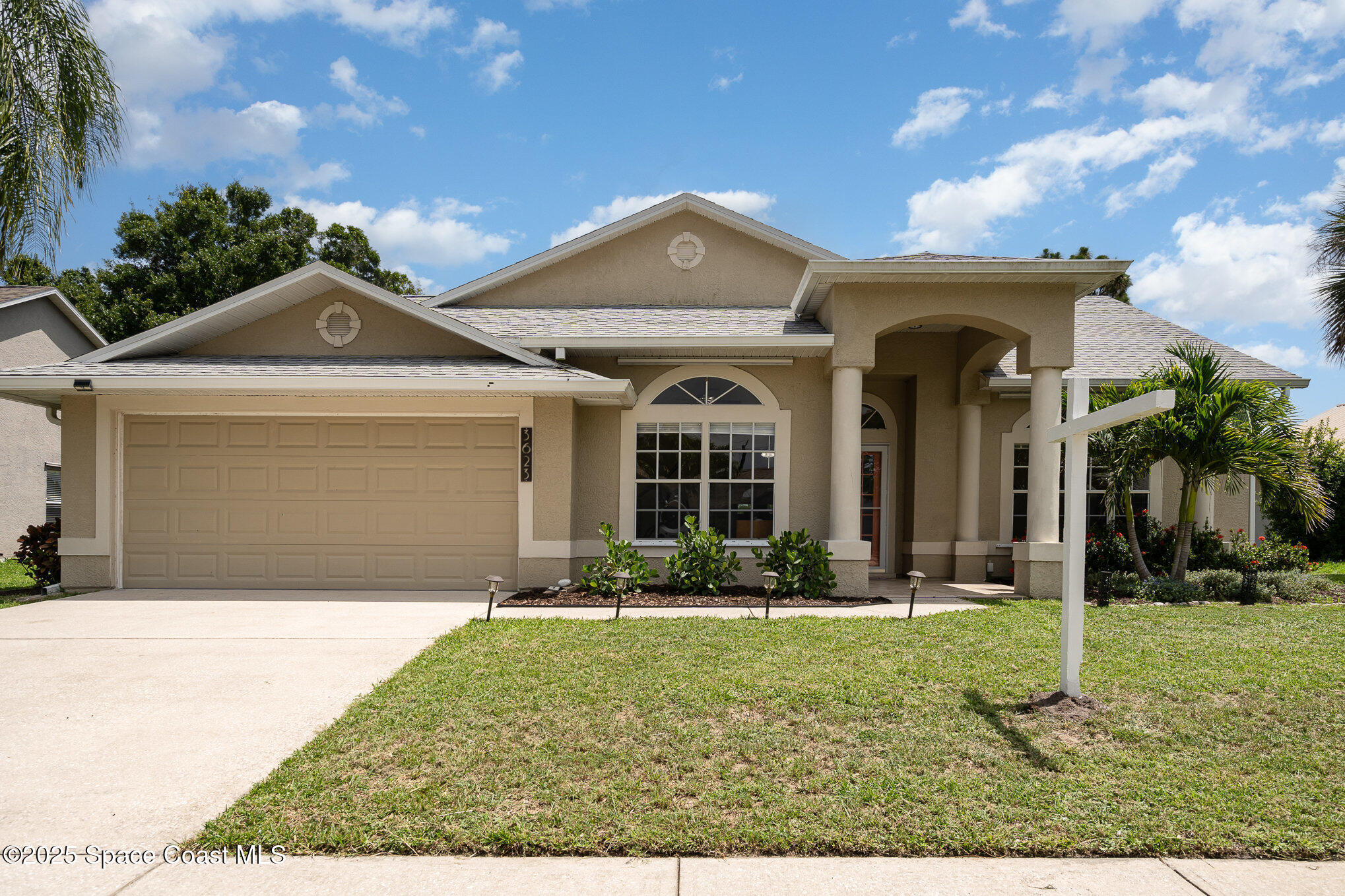 3623 Egret Drive Melbourne, FL 32901 - Photo 1 of 25 a front view of a house with garden