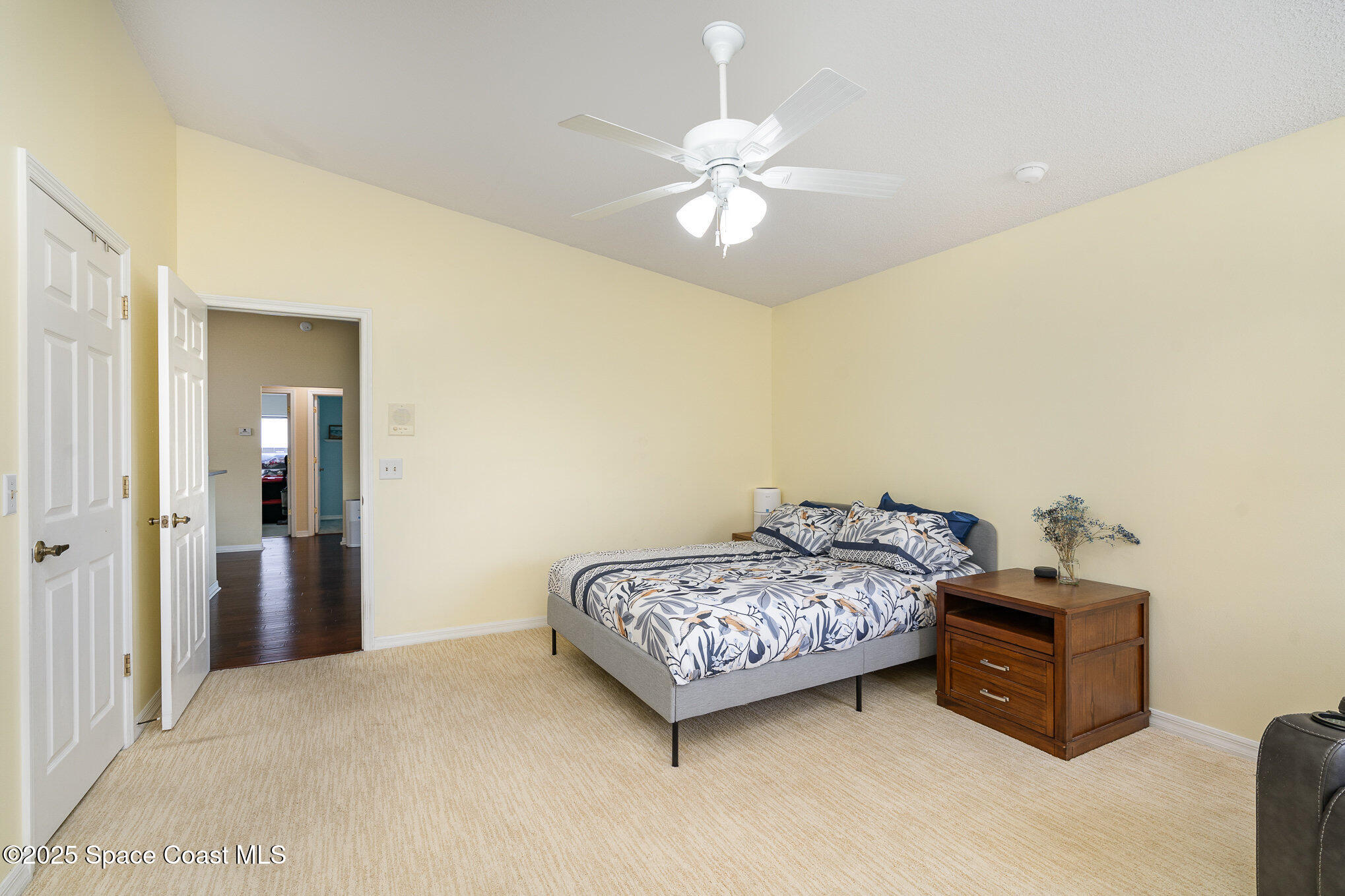 3623 Egret Drive Melbourne, FL 32901 - Photo 12 of 25 a bedroom with a bed and a chandelier
