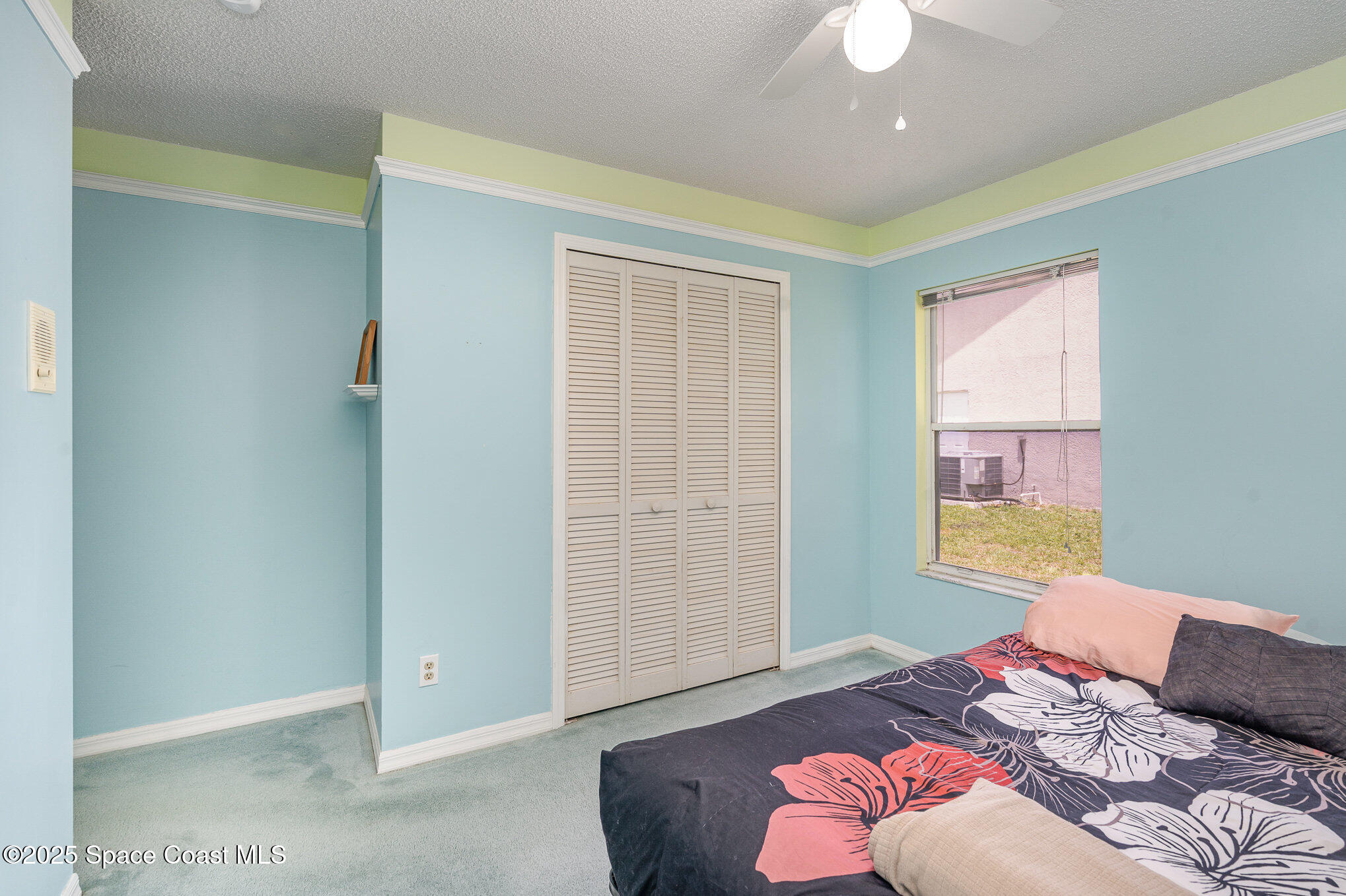 3623 Egret Drive Melbourne, FL 32901 - Photo 17 of 25 a bedroom with a bed and a chandelier