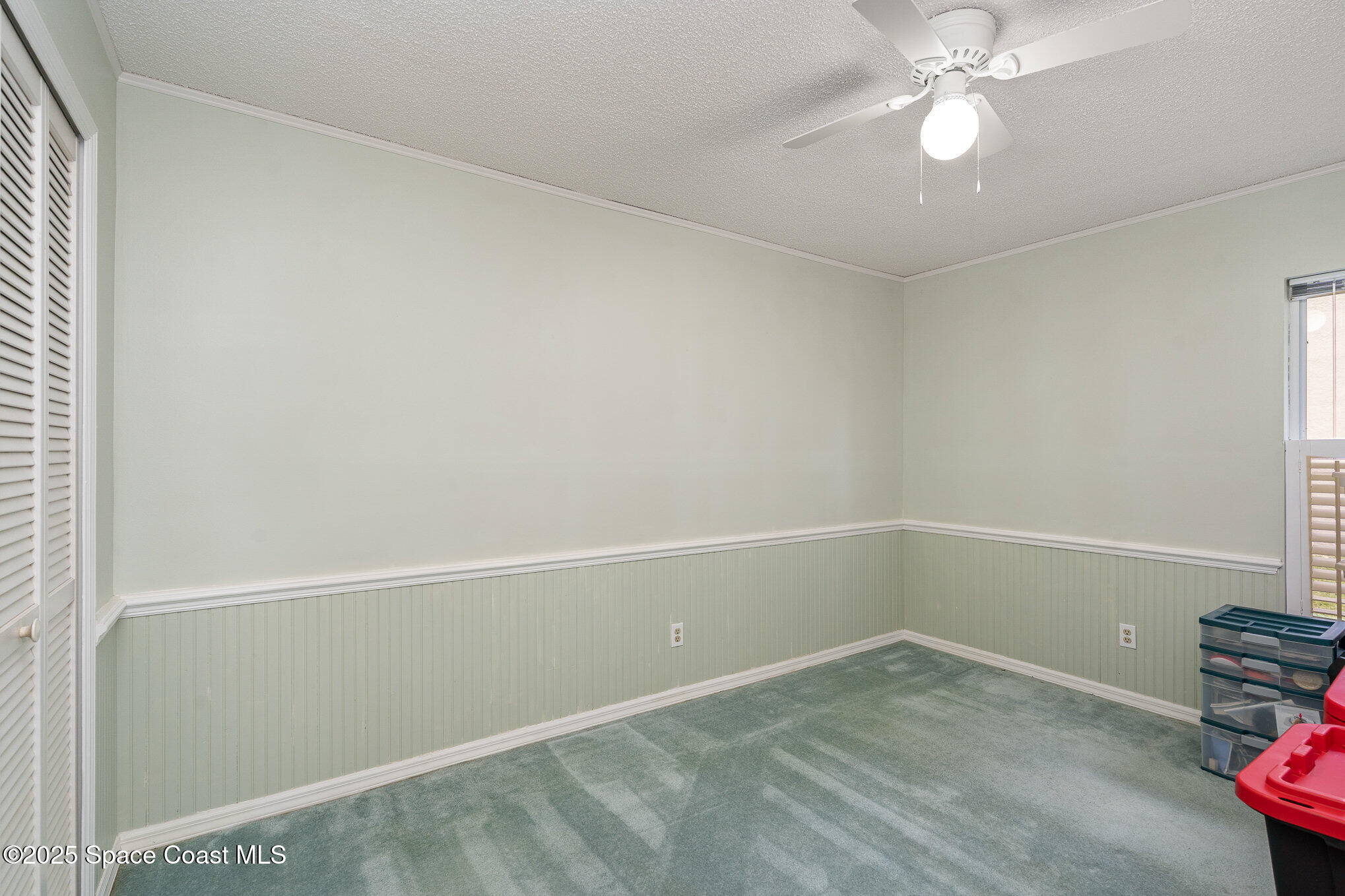 3623 Egret Drive Melbourne, FL 32901 - Photo 20 of 25 an empty room with a chandelier fan