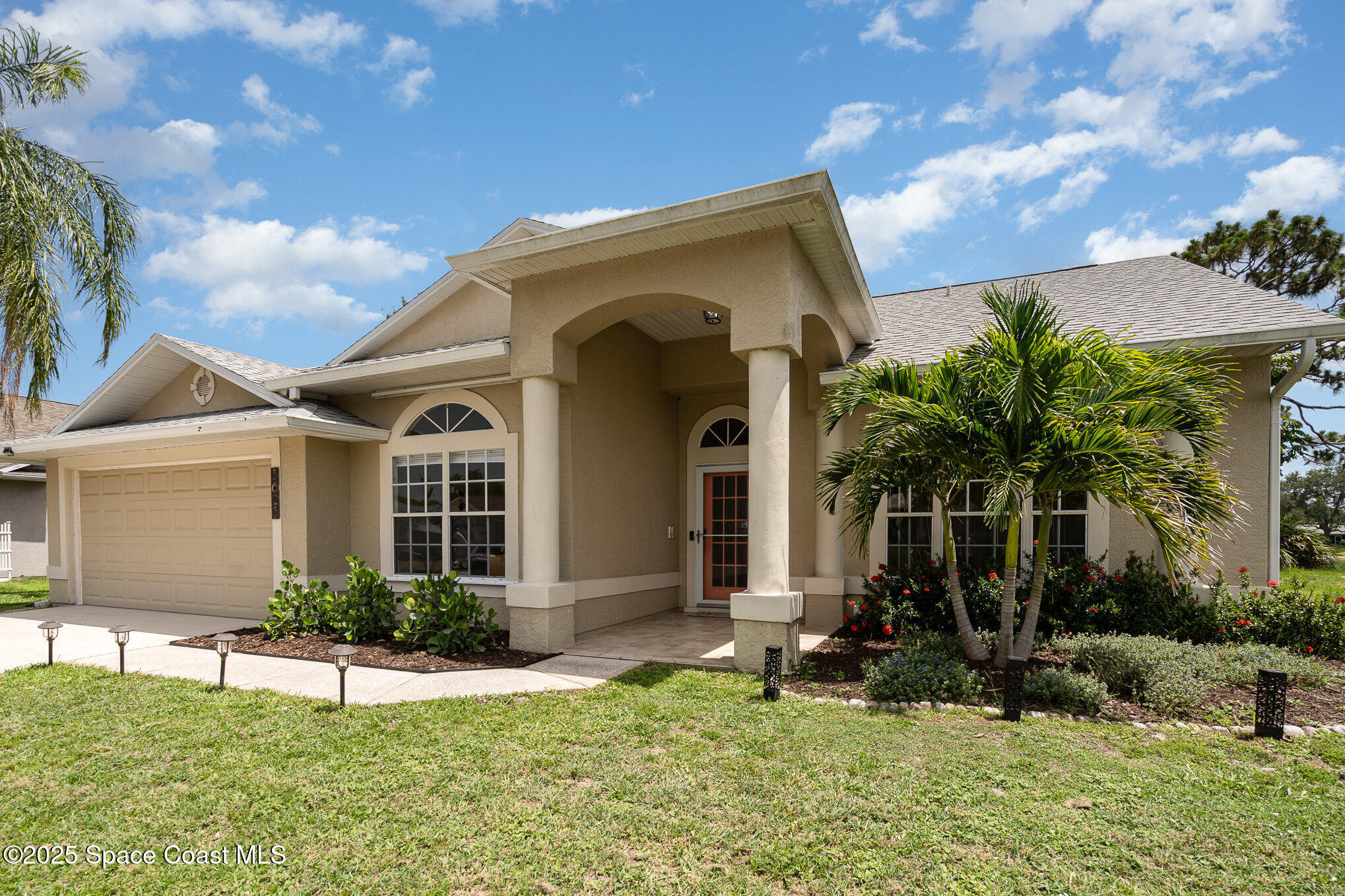 3623 Egret Drive Melbourne, FL 32901 - Photo 2 of 25 a front view of a house with a yard