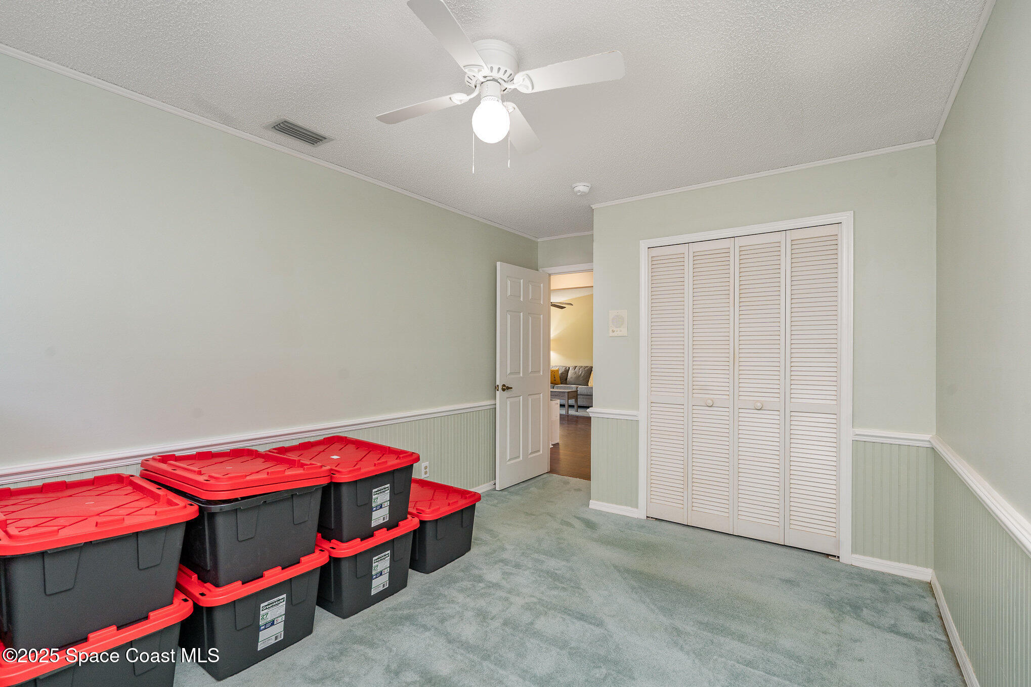 3623 Egret Drive Melbourne, FL 32901 - Photo 21 of 25 a bedroom with a bed and a chandelier