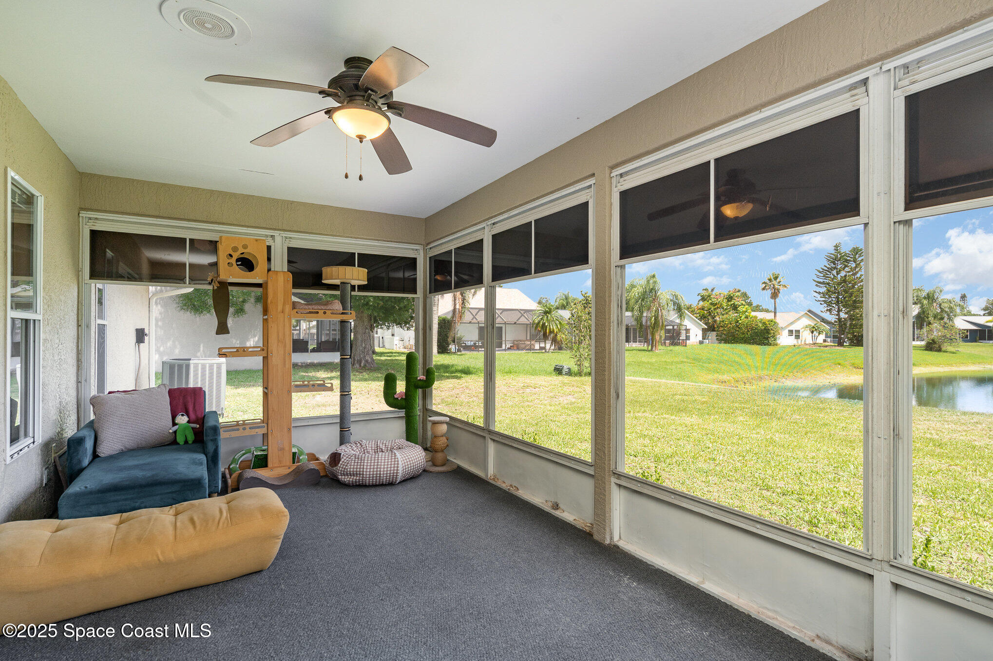 3623 Egret Drive Melbourne, FL 32901 - Photo 22 of 25 a living room with hardwood floor and ceiling fan