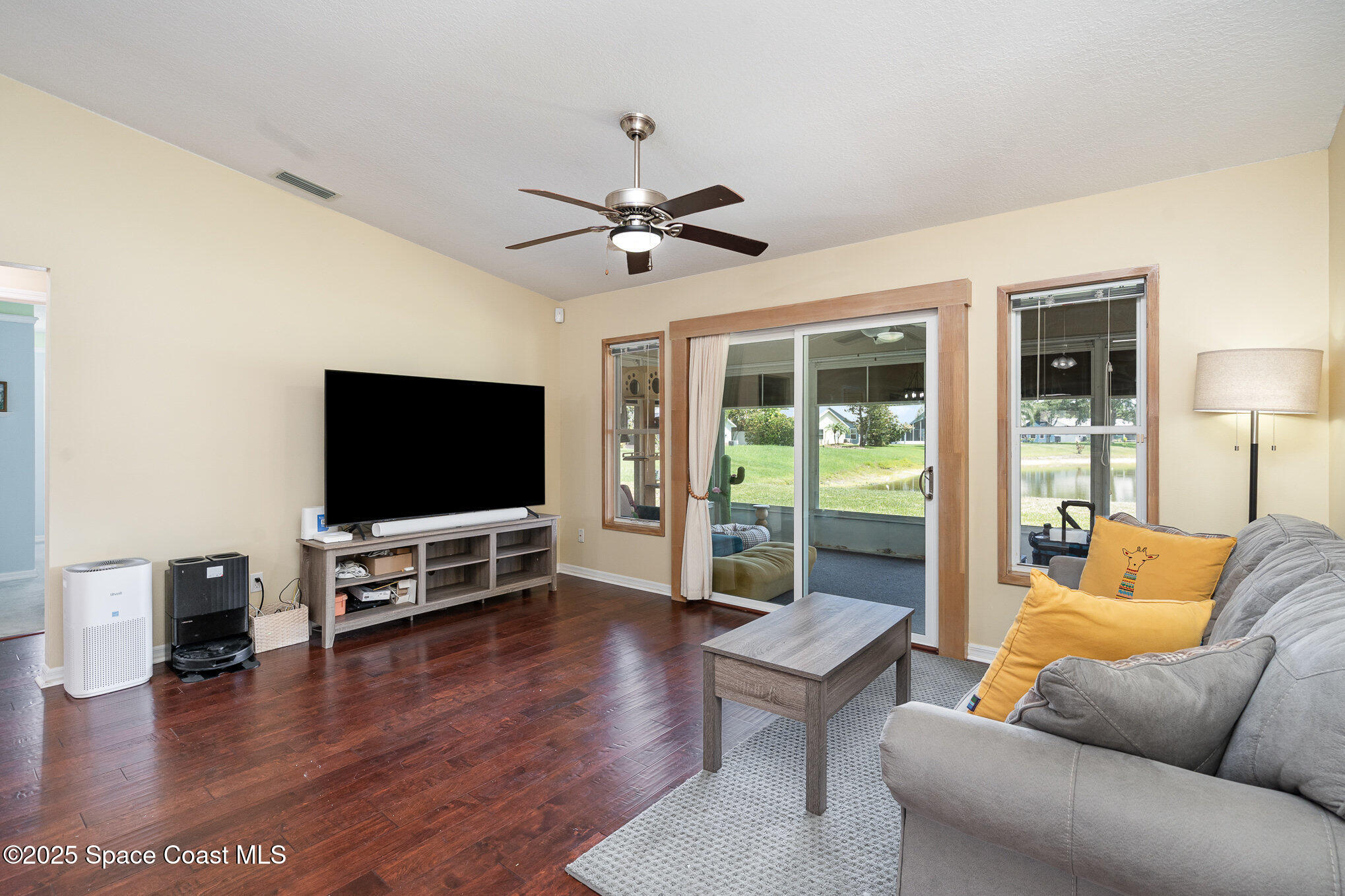 3623 Egret Drive Melbourne, FL 32901 - Photo 6 of 25 a living room with furniture and a flat screen tv
