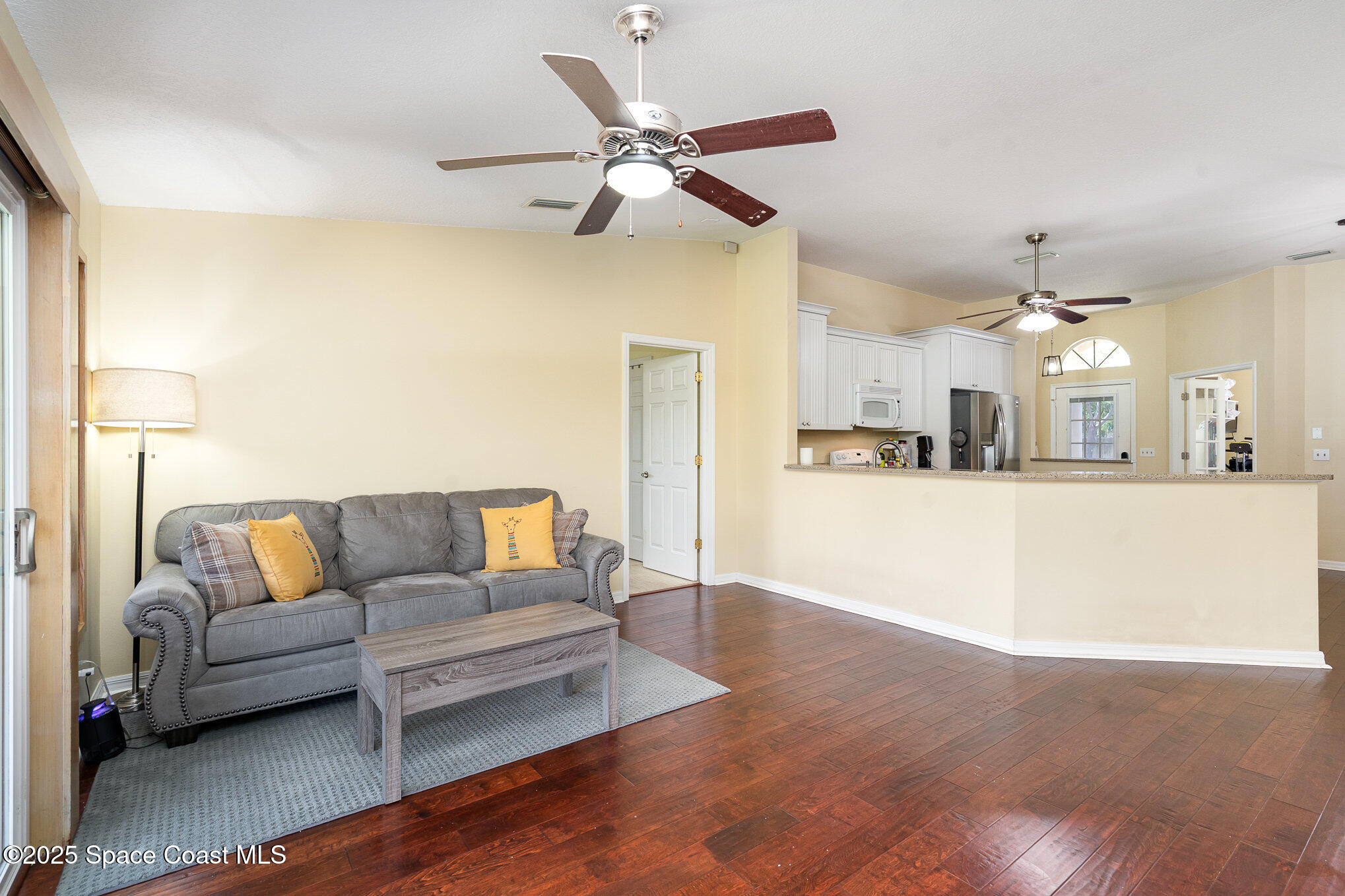 3623 Egret Drive Melbourne, FL 32901 - Photo 7 of 25 a living room with furniture and kitchen view