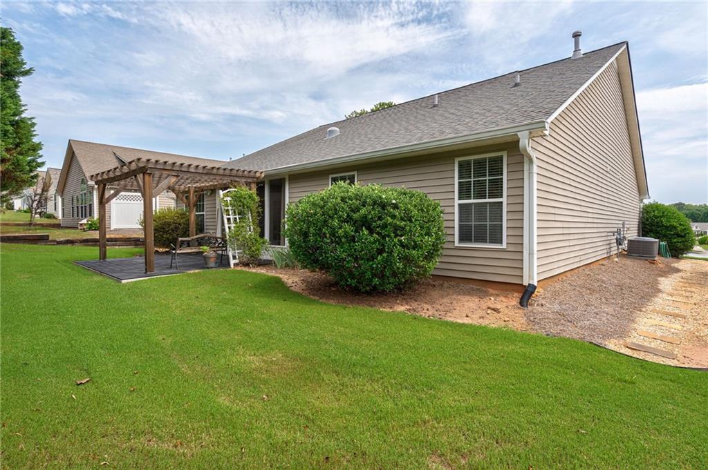 245 Memory Lane Winder, GA 30680 - Photo 39 of 62 a front view of a house with garden