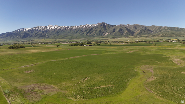 320 South 5400 West Logan, UT 84321 - Photo 36 of 42 Expansive green fields with distant snow-capped mountains under a clear blue sky
