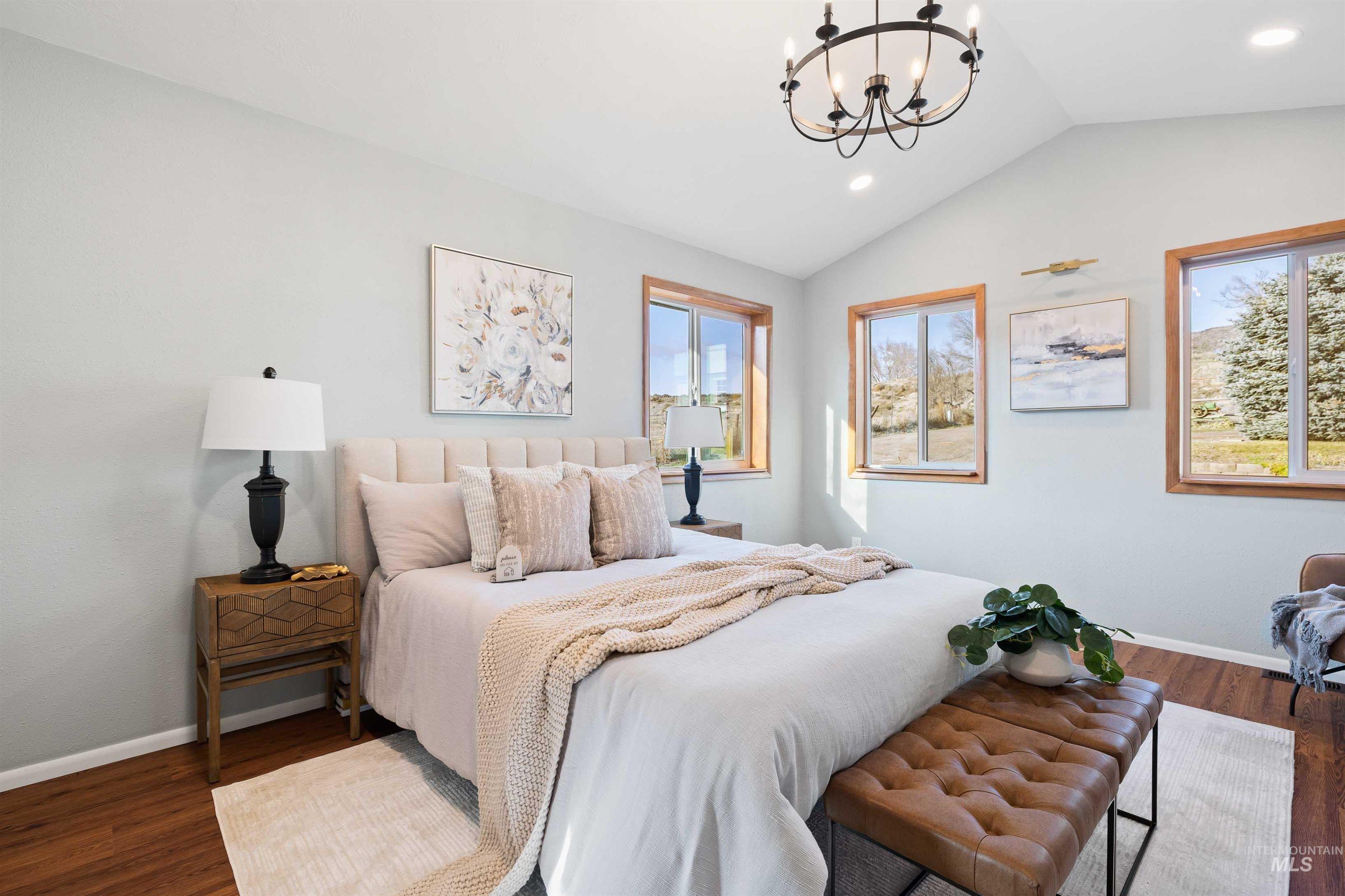 853 Pottery Road Bliss, ID 83314 - Photo 15 of 50 Bedroom featuring vaulted ceiling, a chandelier, dark wood-style floors, and recessed lighting