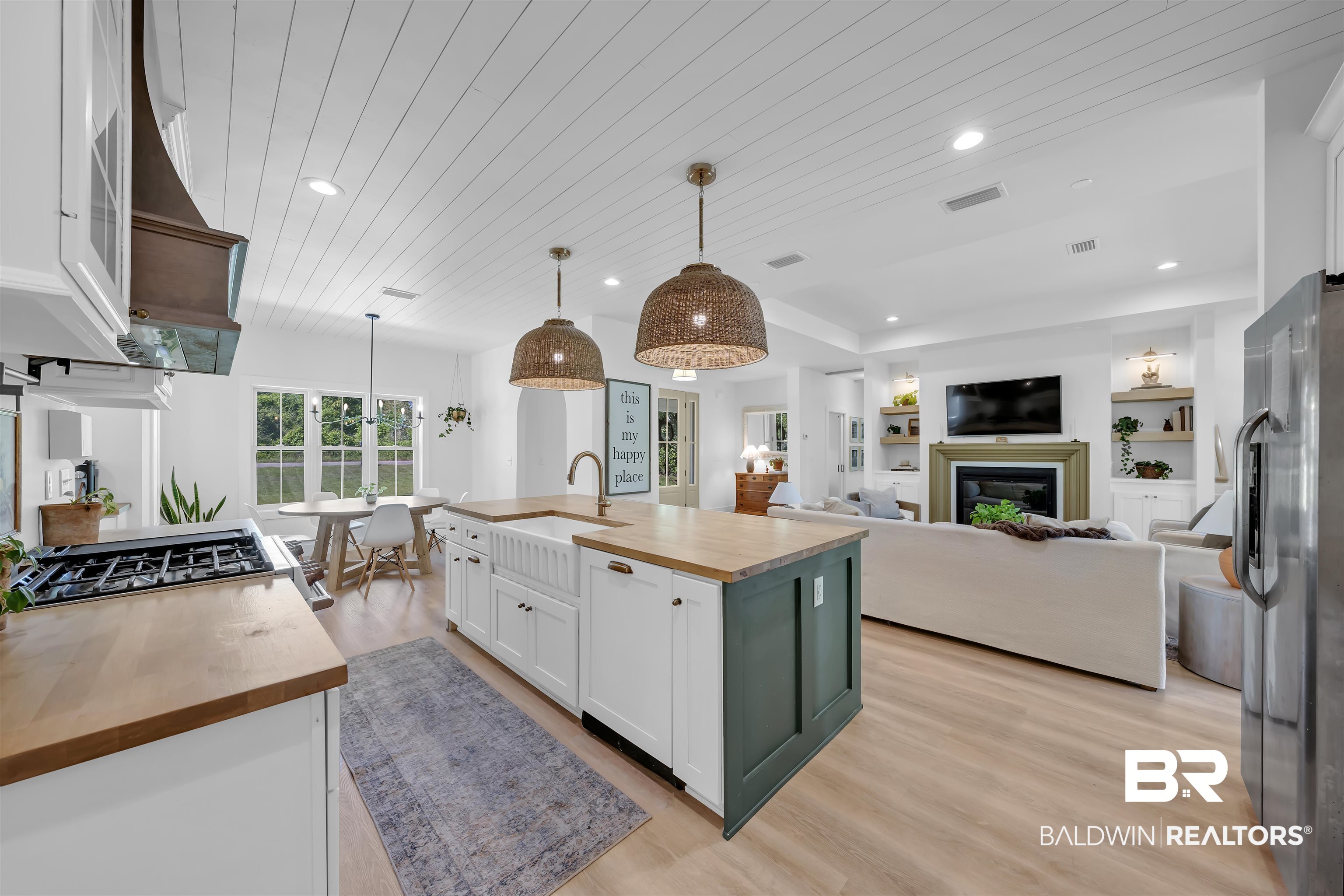 19058 James Road Gulf Shores, AL 36542 - Photo 49 of 49 Kitchen featuring wooden counters, white cabinetry, wood ceiling, open floor plan, and an island with sink