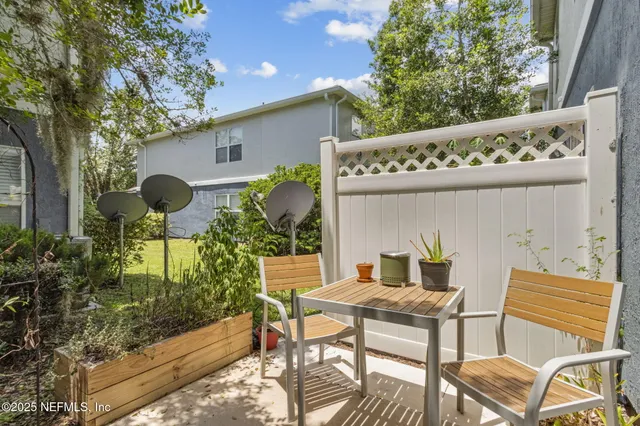a backyard of a house with table and chairs