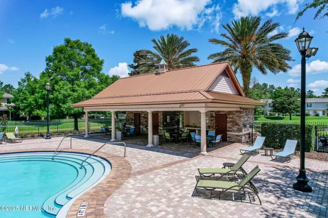 a view of a swimming pool with an outdoor space and seating area