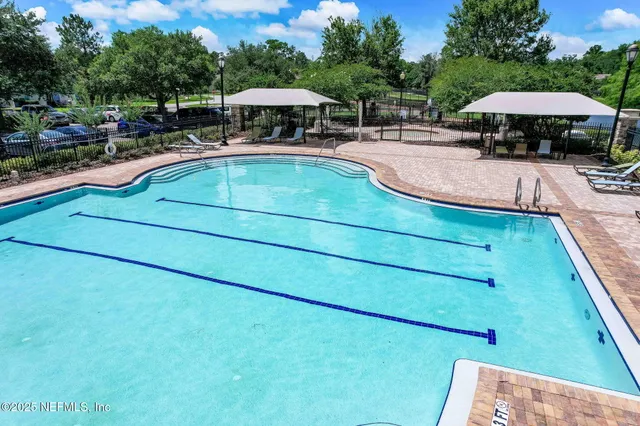 a swimming pool with outdoor seating yard barbeque oven and outdoor seating
