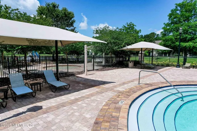 a view of a chairs and table in backyard