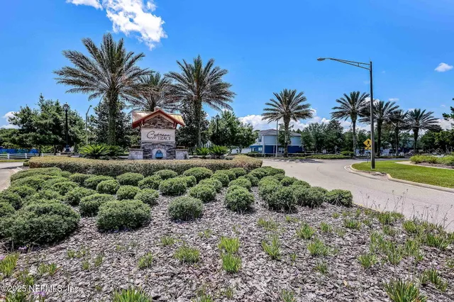 an aerial view of residential house with outdoor space and trees all around