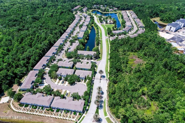 an aerial view of a house with outdoor space and street view