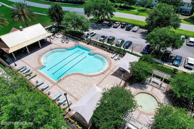 an aerial view of a house with swimming pool and patio