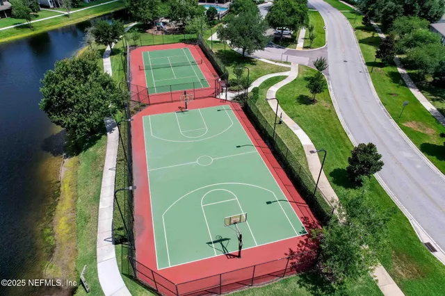 an aerial view of a pool a yard pool patio and outdoor seating