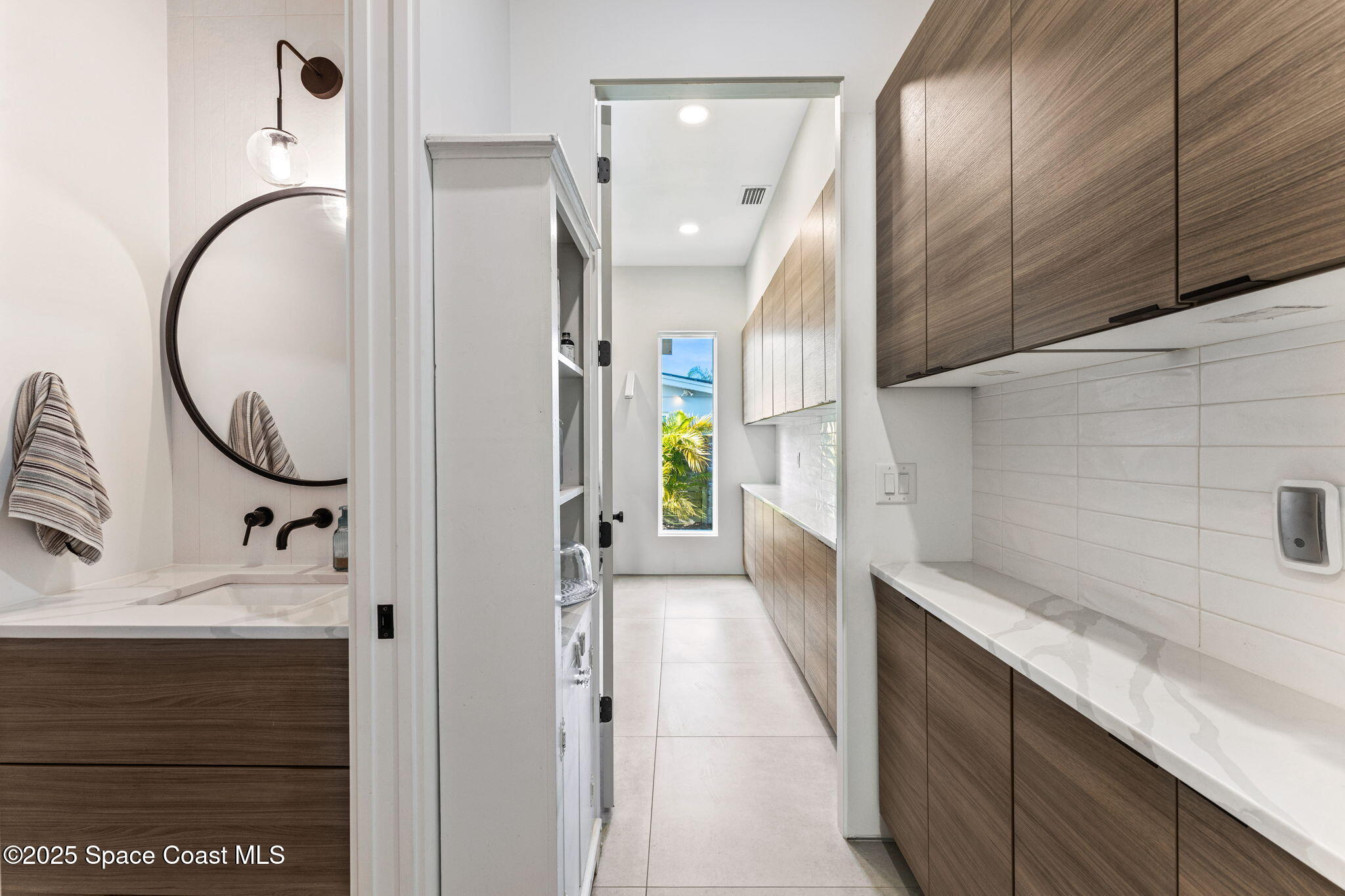 2619 Forest Drive Melbourne, FL 32901 - Photo 15 of 44 a bathroom with a sink and a mirror