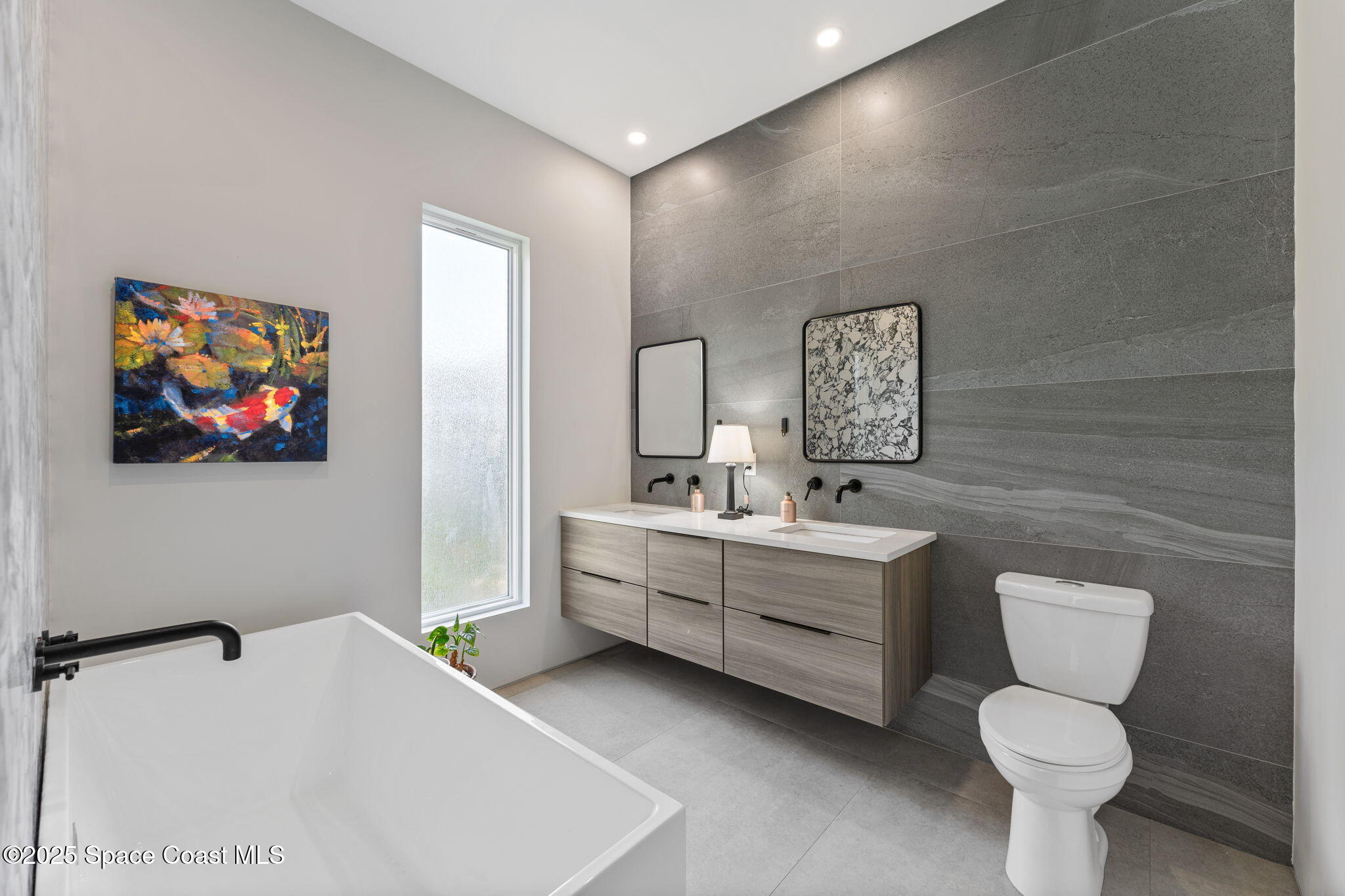 2619 Forest Drive Melbourne, FL 32901 - Photo 20 of 44 a bathroom with a toilet a sink and mirror