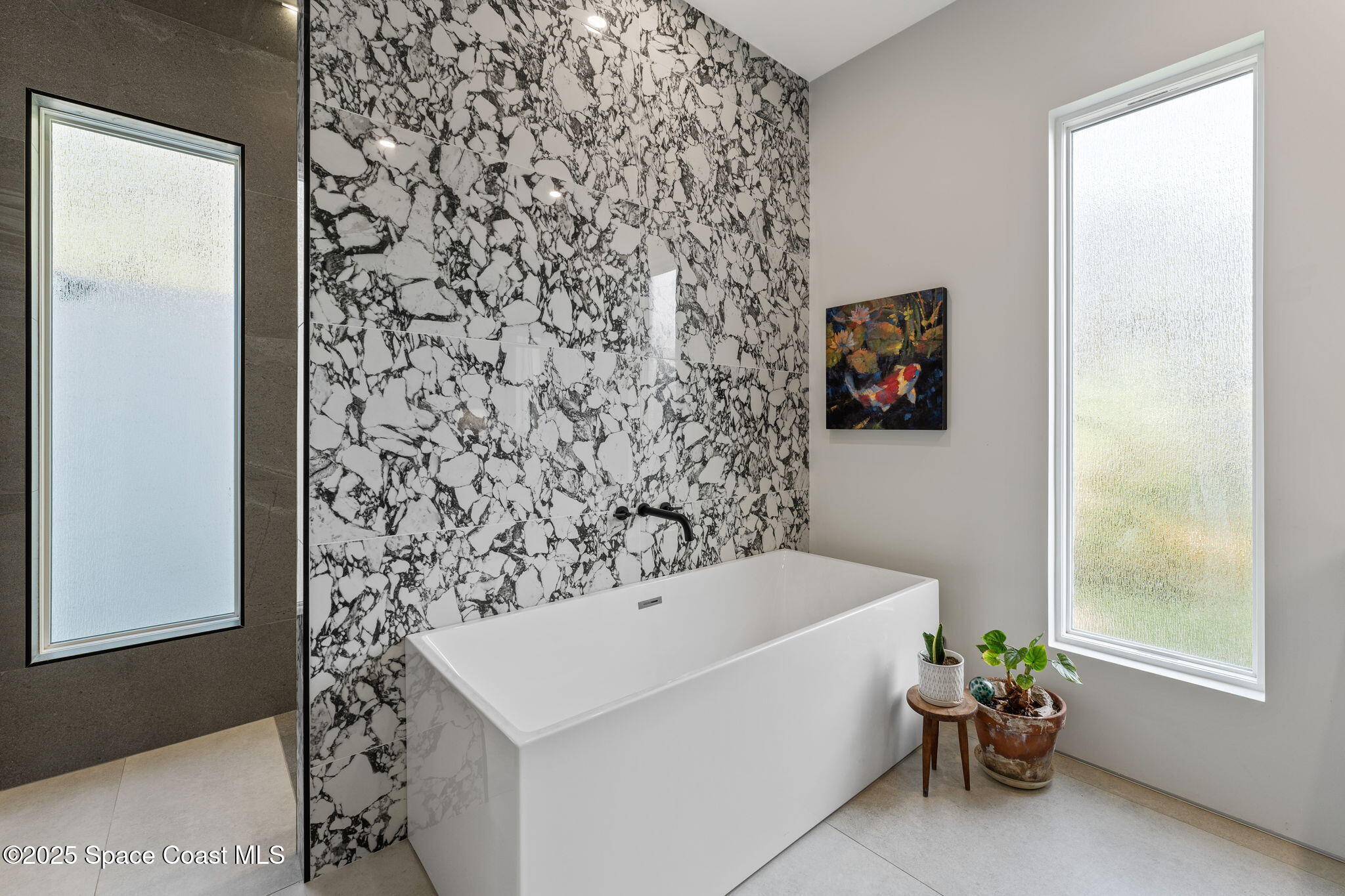 2619 Forest Drive Melbourne, FL 32901 - Photo 21 of 44 a bathroom with a bathtub and a window