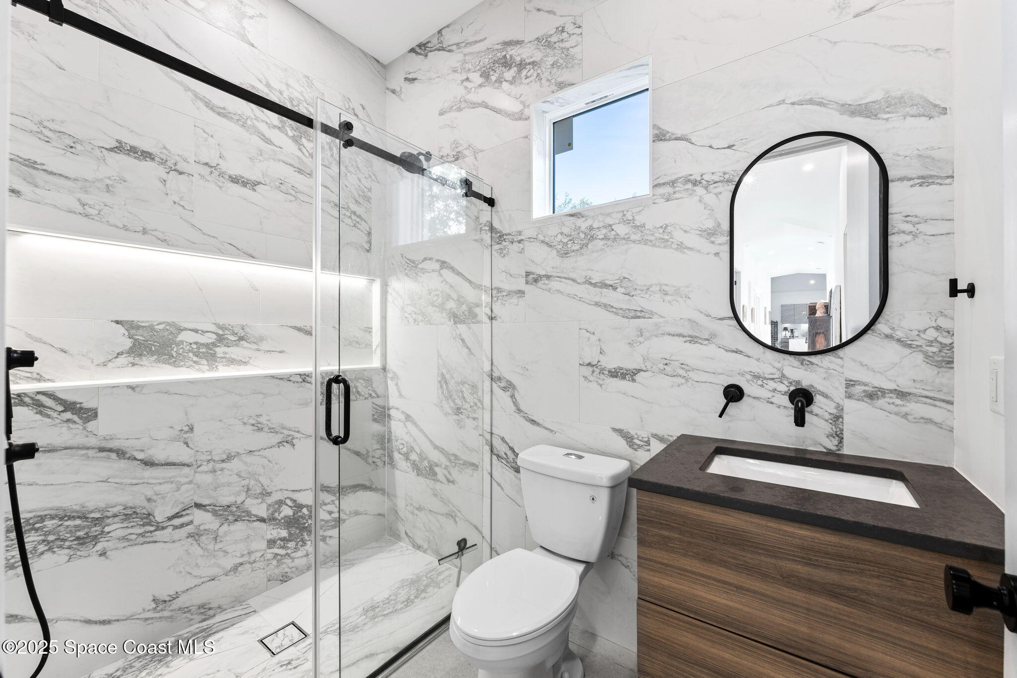 2619 Forest Drive Melbourne, FL 32901 - Photo 24 of 44 a bathroom with a sink mirror toilet and shower