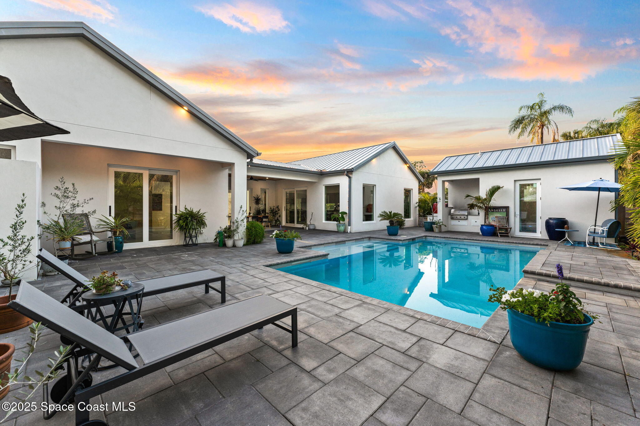 2619 Forest Drive Melbourne, FL 32901 - Photo 30 of 44 a view of house with swimming pool outdoor seating and house in the background