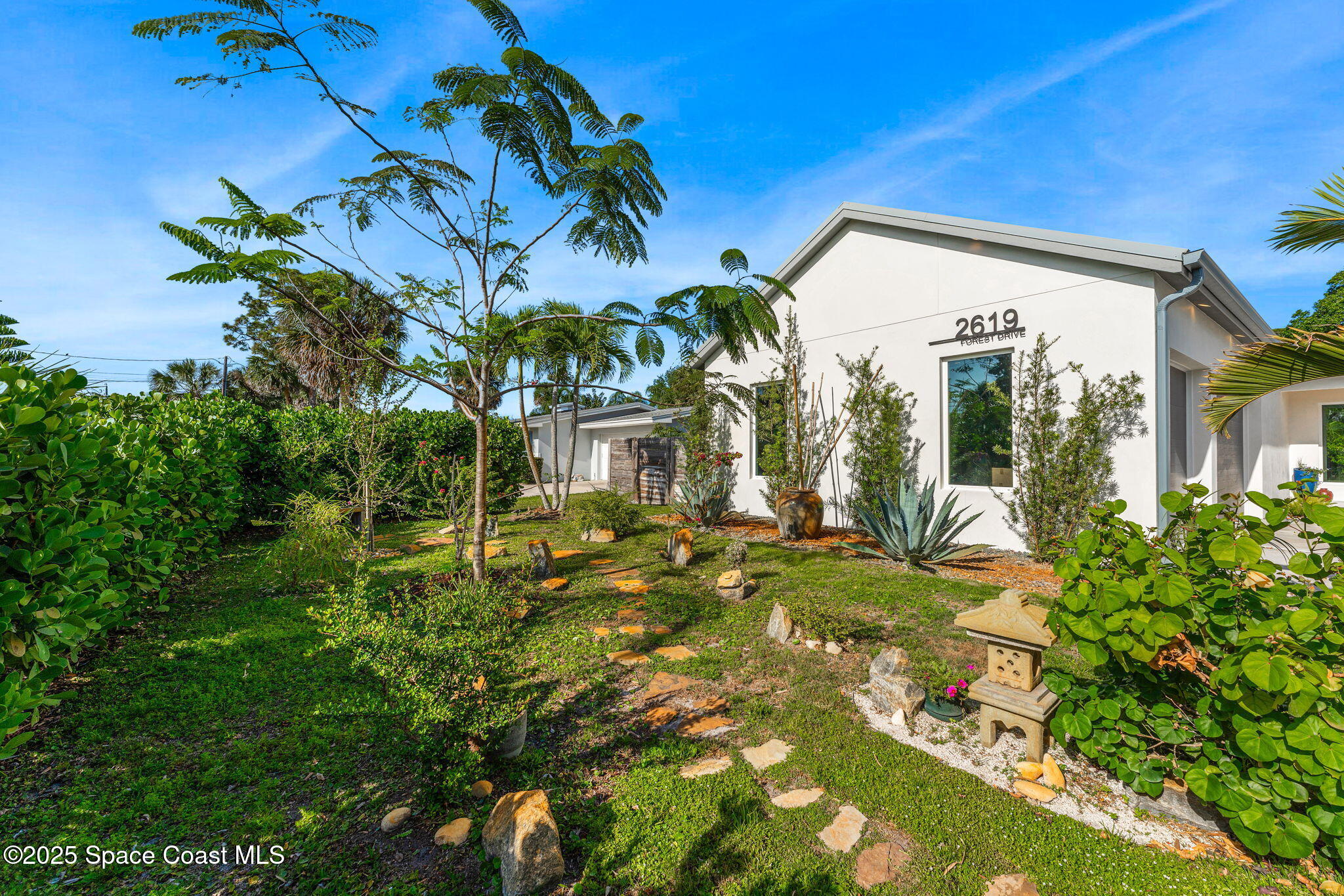 2619 Forest Drive Melbourne, FL 32901 - Photo 41 of 44 a view of a house with a flower garden