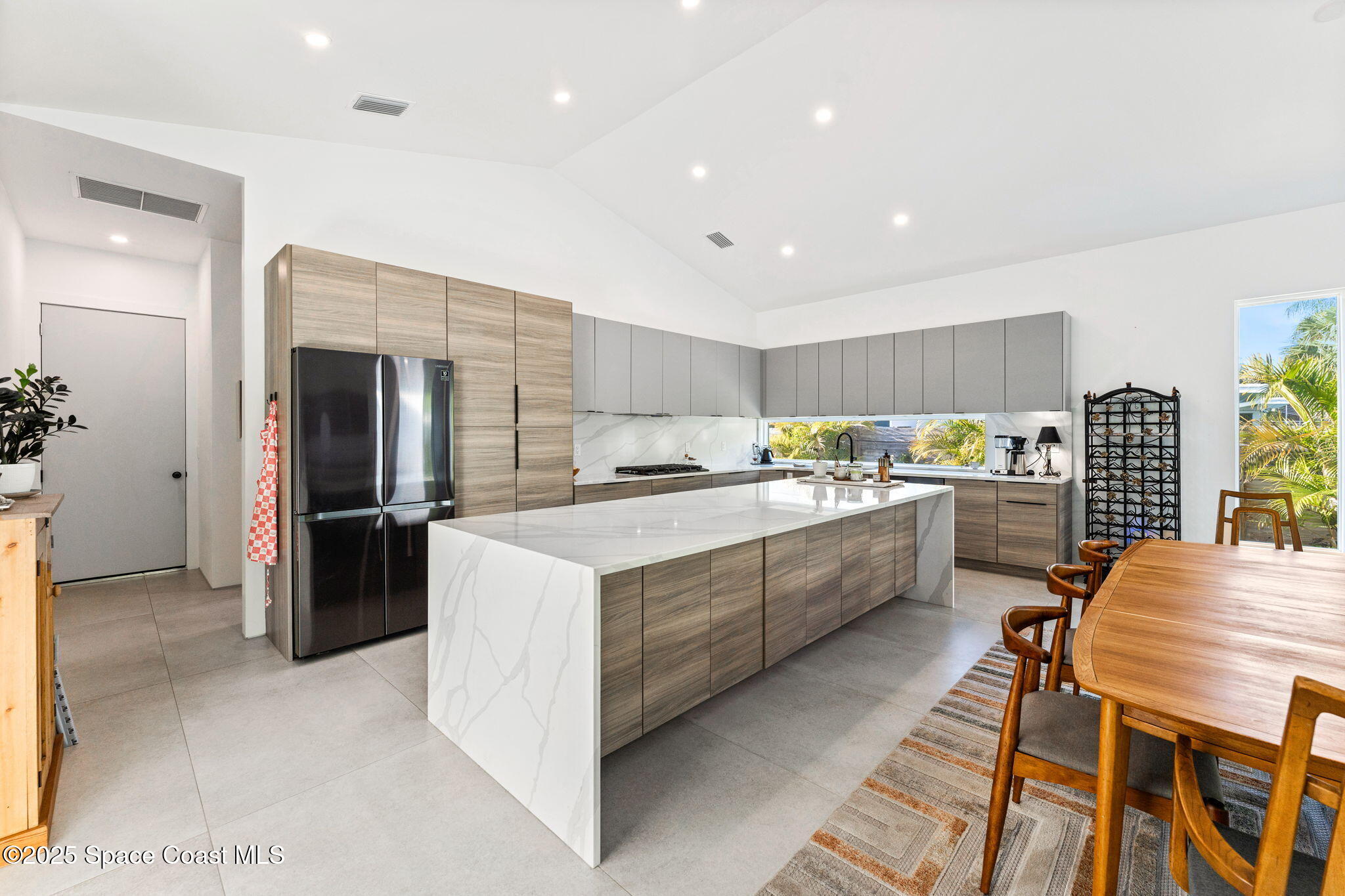 2619 Forest Drive Melbourne, FL 32901 - Photo 7 of 44 a kitchen with a sink and chairs