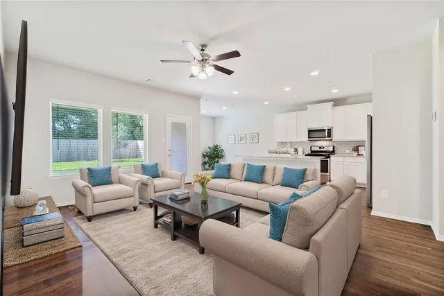 a living room with furniture and kitchen view
