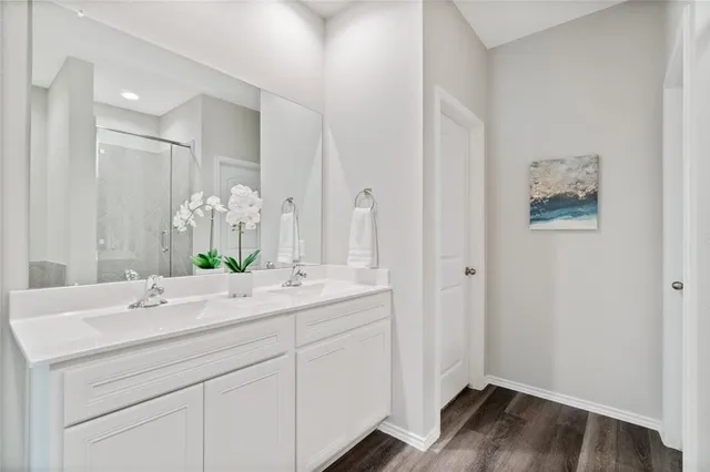 a bathroom with a double vanity sink and mirror