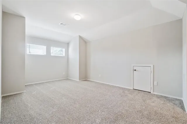 a bedroom with bed and a window