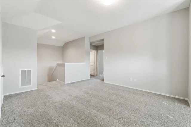 a bedroom with a bed and a potted plant